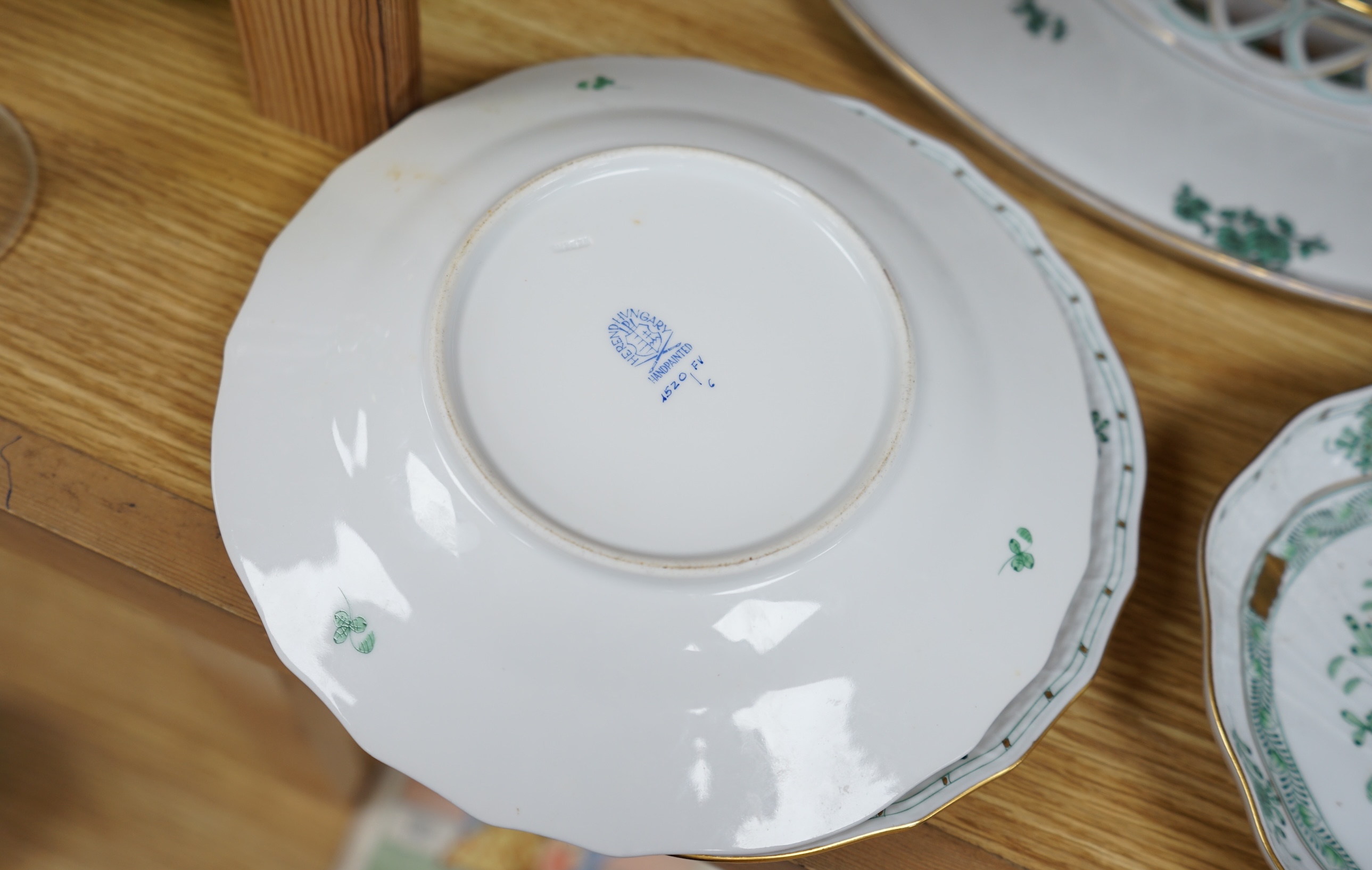 A Herend green decorated tray, 26cm wide, a similar pair of dishes and a basket, together with another larger porcelain tray, 39cm wide (5). Condition - good.